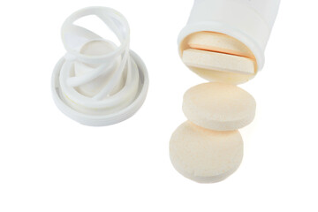 Vitamin C soluble tablets from a tube on a white background.