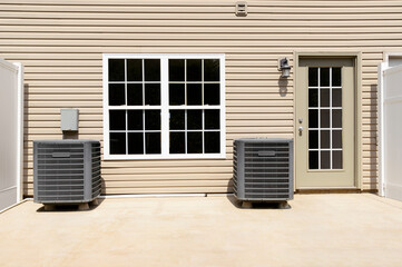Twin HVAC Air Conditioning Units On A Condo Patio
