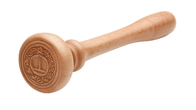 A wooden spoon with a round wooden top and a letter T on it