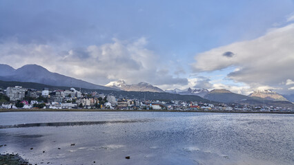 Ushuaia, located in Tierra del Fuego, Argentina. It is known as the southernmost city in the world and is surrounded by snow-capped mountains, including the Martial Mountains visible in the background