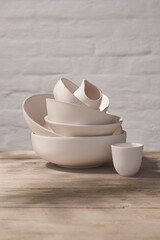 Ceramics workshop, contemporary photography with raw clay and white dishes.