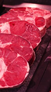 Raw beef meat osso buco shank steak lower part of cows foreleg. Red meat selection in butchers shop, fresh beef osso.