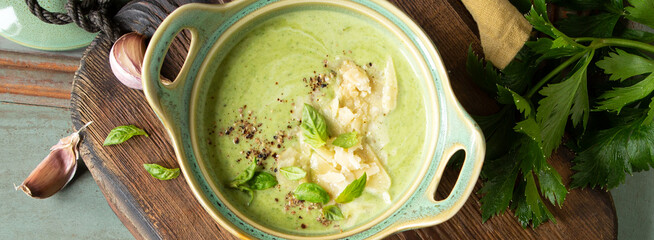 casserole with green vegetable soup and parmesan cheese on the table
