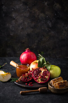 Rosh Hashana concept with honey, apple and pomegranate