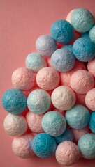 Colorful cotton candies in blue and pink on a soft pink background
