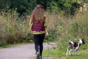 Woman walking with her dog at the park