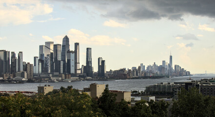 view of midtown manhattan frm weehawken waterfront (hudson river west new york city skyline skyscrapers sightseeing travel tourism destination) nyc dramatic sky harbor vista scenic buildings nj jersey