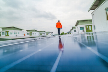 engineer man inspects construction of solar cell panel or photovoltaic cell by electronic device....