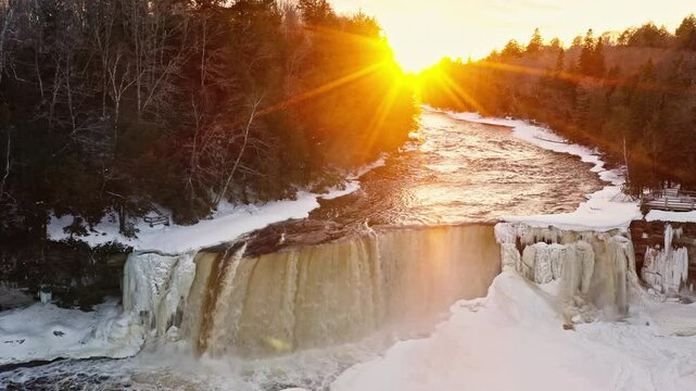 Sun Setting Above Wintery Waterfall