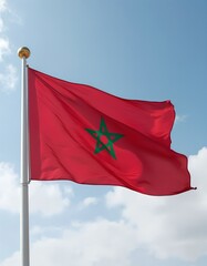 Morocco flag waving on a tall flagpole against a bright blue sky.Vertical image.

