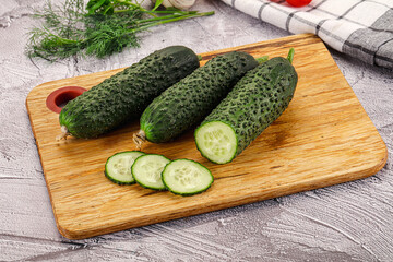 Raw green cucumbers with slices
