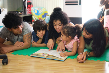 Latin family is enjoying quality time while reading a book together