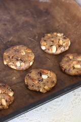 Cookie dough. With peanuts and chocolate. Close-up.