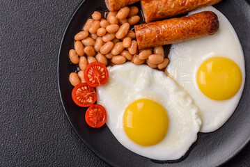 Full English breakfast with boiled eggs, beans, sausages, tomatoes