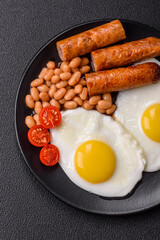 Full English breakfast with boiled eggs, beans, sausages, tomatoes