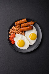 Full English breakfast with boiled eggs, beans, sausages, tomatoes