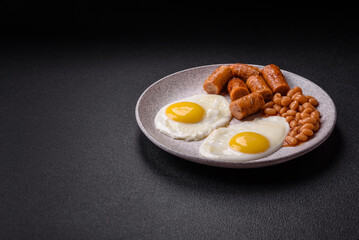 Full English breakfast with boiled eggs, beans, sausages, tomatoes