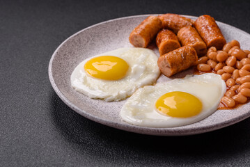 Full English breakfast with boiled eggs, beans, sausages, tomatoes