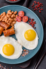 Full English breakfast with boiled eggs, beans, sausages, tomatoes