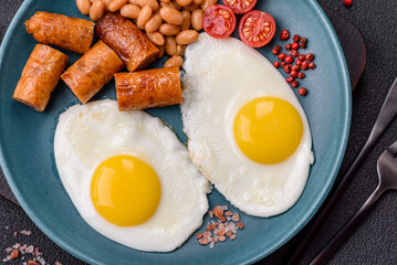 Full English breakfast with boiled eggs, beans, sausages, tomatoes