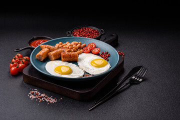 Full English breakfast with boiled eggs, beans, sausages, tomatoes