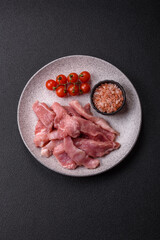 A pieces of raw fresh pork on a wooden cutting board with spices and herbs