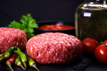ingredients for making hamburger. fresh ground meat with seasonings. fresh vegetables.