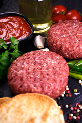 ingredients for making hamburger. fresh ground meat with seasonings. fresh vegetables.