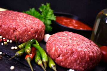 ingredients for making hamburger. fresh ground meat with seasonings. fresh vegetables.