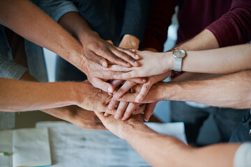 Employees, hands and pile in huddle for solidarity, teamwork and closeup in company mission. Business people, stack and circle for motivation with target, together and group for work collaboration