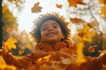diverse kid playing with autumn leaves in the park backlit, looking up in his future. Banking, accounts for children in bank, education, family time. 