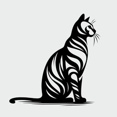 A black and white cat with stripes sits on its haunches. The cat is looking to the right