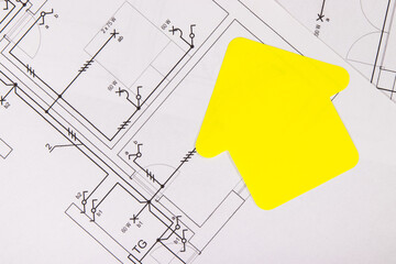 Construction drawing of electric installation, paper in shape of house. Building or buying of home