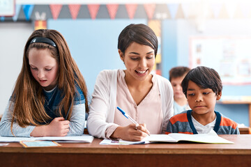 Children, writing and teacher for education in classroom of learning, study quiz and drawing...