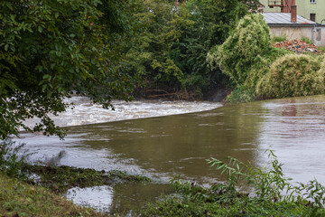 Weir on the Svitava River in the city of Brno, a local part of the Obrany. Big water after rain.