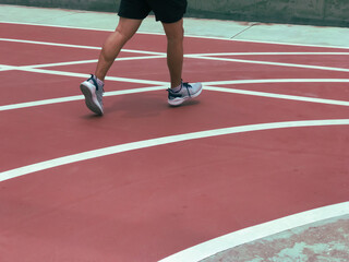 a person running on a red running track