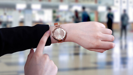 woman looking time at airport