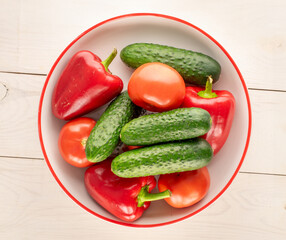 Fresh ripe vegetables on wooden table, macro, top view.