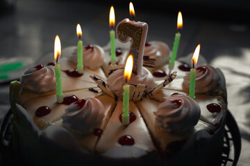 Number seven on the cake. Festive cake with candles. Child's seventh birthday