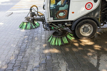 Cleaning up trash in a park using a machine.