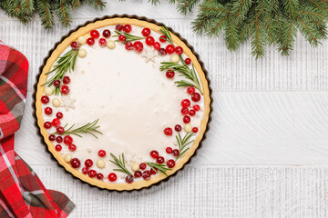 Christmas cake adorned with berries and rosemary