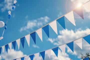 A colorful blue and white bunting hangs against a clear blue sky, perfect for outdoor decorations or festivals