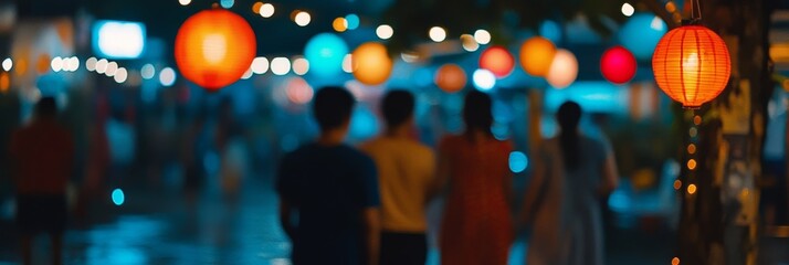Brightly colored lanterns light up a bustling market street in the evening as visitors enjoy food stalls and artisanal crafts