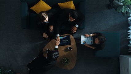Top down aerial view of skilled business man handed out business document to investor while manager placed tablet display financial statistic graph on table and shake hand with manager. Directorate.