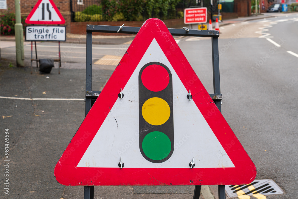 Wall mural uk traffic sign stating traffic lights ahead on a red and white warning triangle