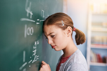 Kid, blackboard and girl in school, frustrated and stress with thinking, depression and anxiety. Angry, student and writing with autism, learning and lazy with education, upset and emotion with maths