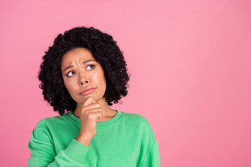 Portrait photo of young intelligent woman with chevelure in green sweatshirt touch chin isolated on pink color background