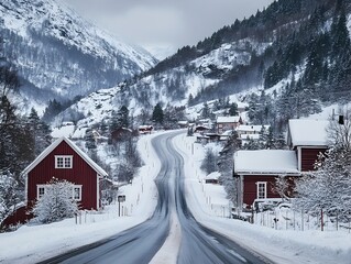 Fototapeta premium Snowy Highway Through a Peaceful Winter Village Nestled in the Mountains