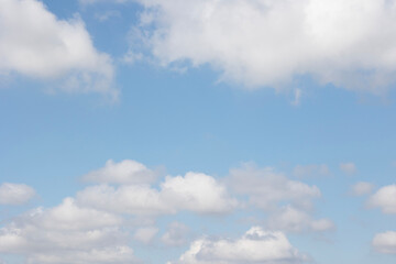 Fluffy Clouds in a Clear Blue Sky on a Beautiful Sunny Day with a Serene Landscape
