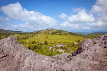View of rocky boulders and grassy mountain peak